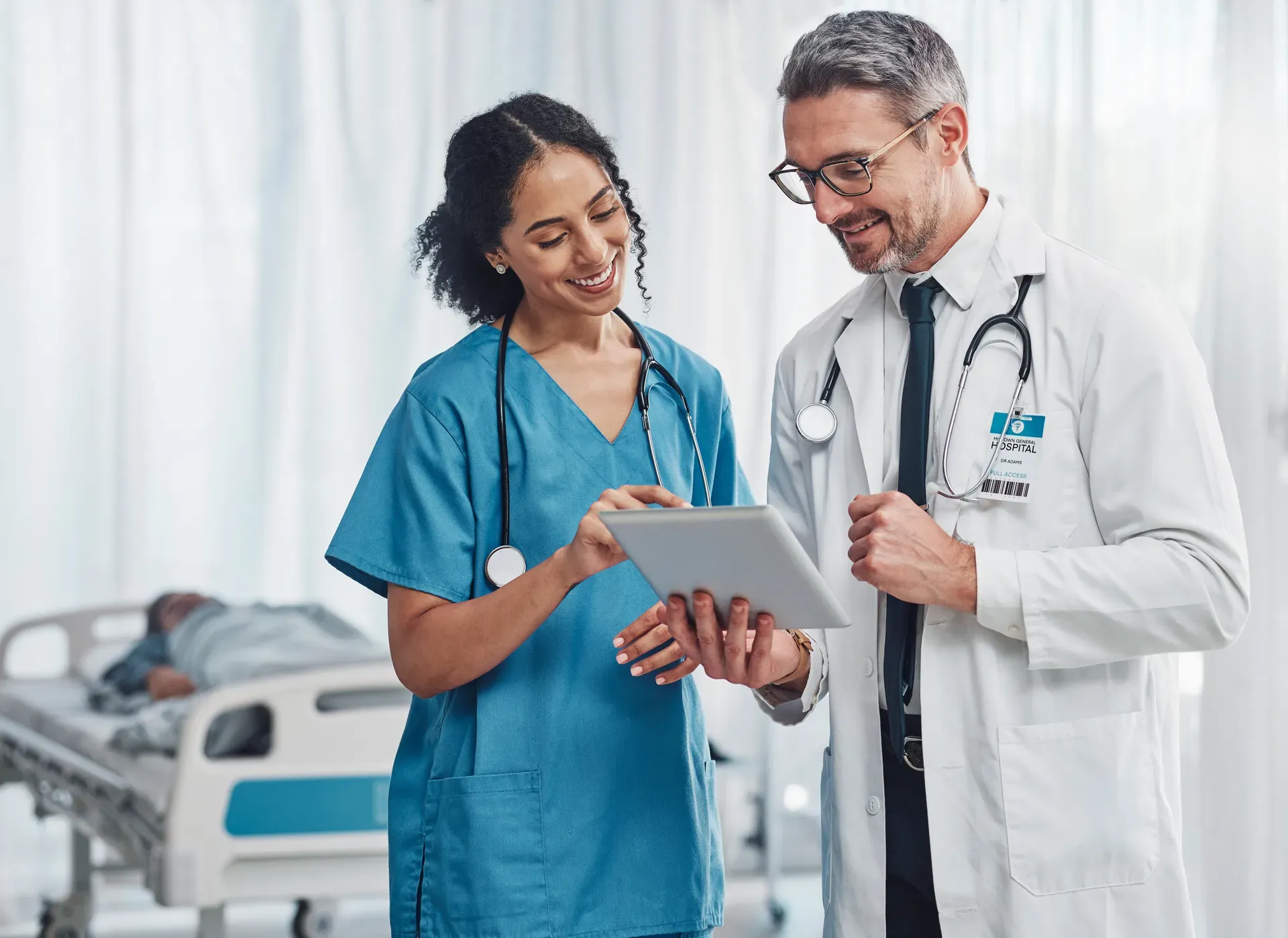 Clinical team reviewing compliance records on a tablet