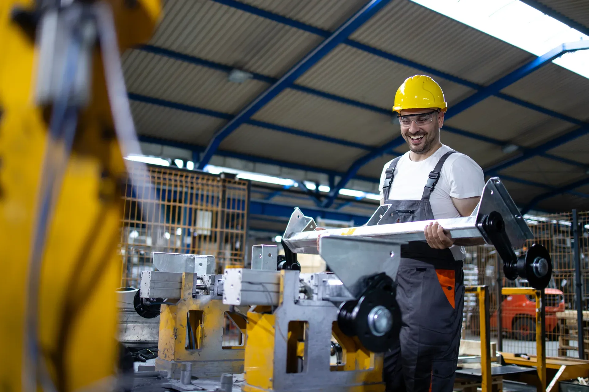 Worker inspecting parts on an industrial production line