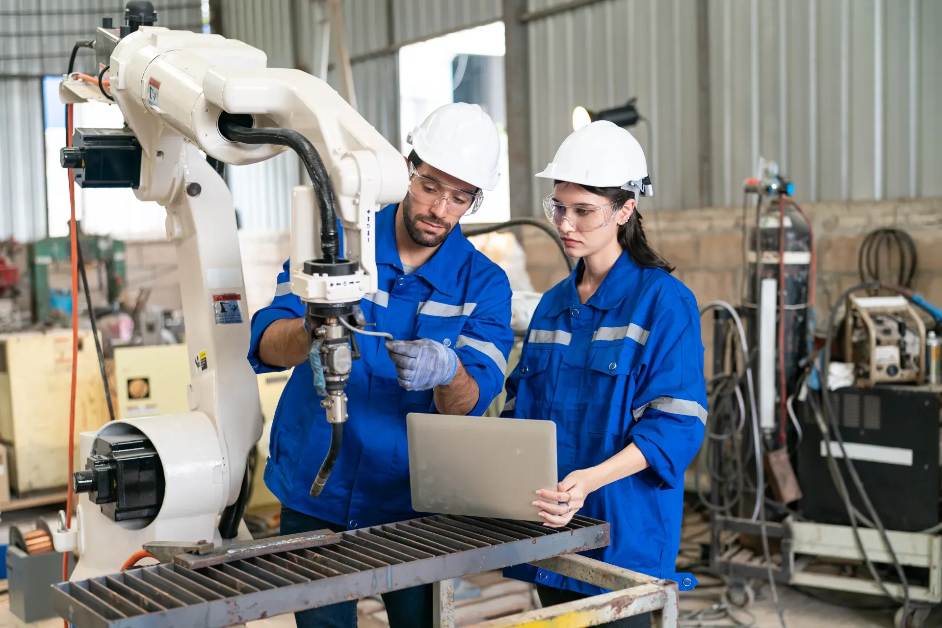 Engineer auditing equipment in a modern factory