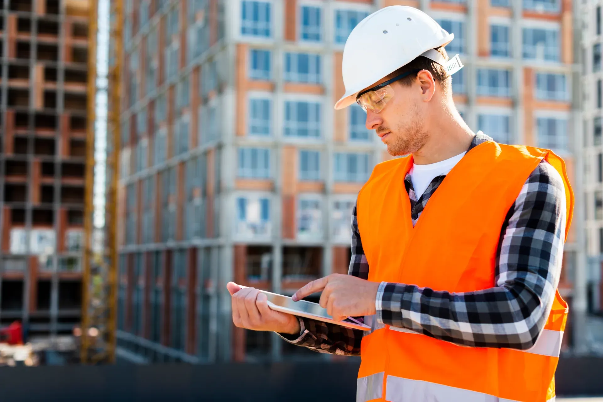 Construction engineer using a tablet on site
